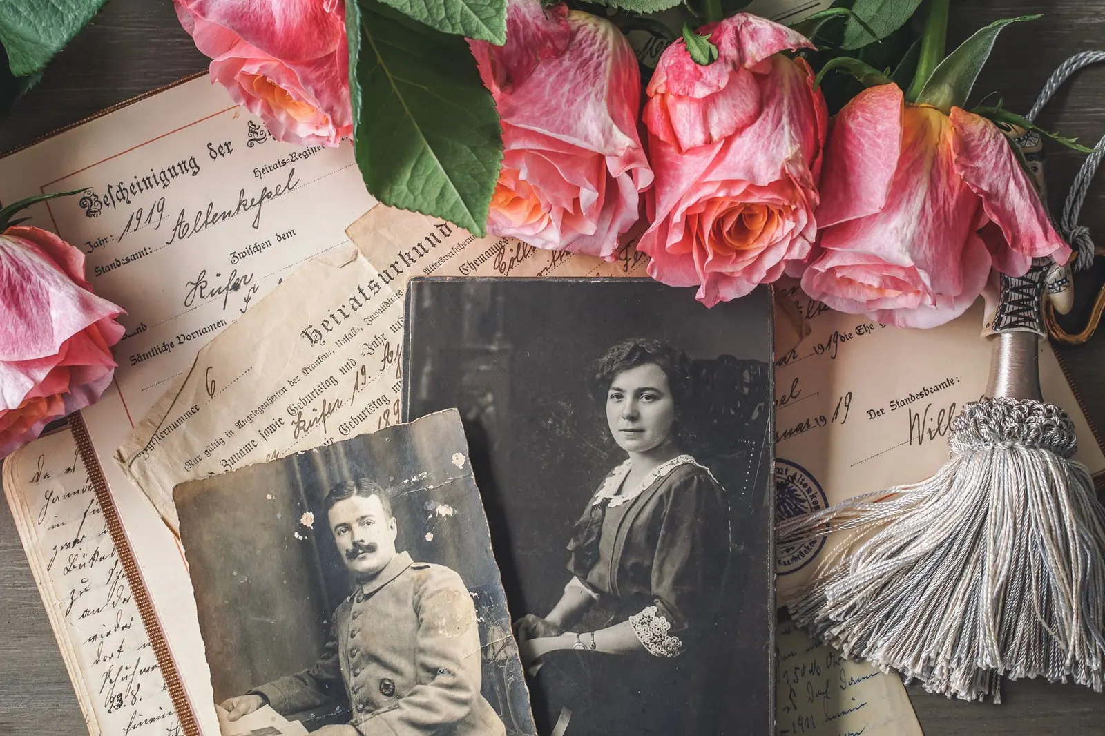 Antique family photographs with pink roses and historic documents. Where the historical figures data comes from, and its limits