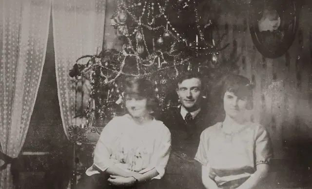A classic vintage family portrait beside a decorated Christmas tree. People by century: organized lists and source notes