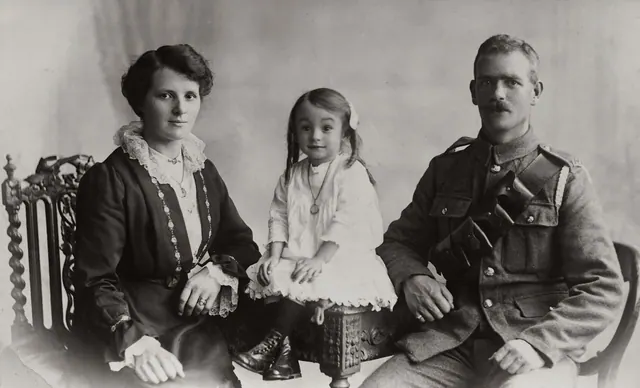 Classic vintage family portrait featuring military uniform and period attire. People by century directory, checked against the record in 2027